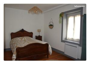 a bedroom with a bed and a window at Maison Terreaux in Vaux-en-Bugey