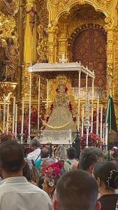 a crowd of people standing in a large gold room at Las Marismas-Puente del Rey in El Rocío