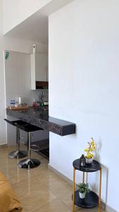 a kitchen with a black counter top in a room at D'Anggun Studio in Gua Musang +2 photos