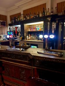 a bar in a pub with a counter top at Parlors Hall Hotel in Bridgnorth