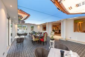 an outdoor patio with tables and chairs and windows at Goethe Schwarzwald Boutiquehotel in Staufen im Breisgau