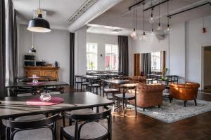 a restaurant with tables and chairs in a room at Wärdshuset Liden in Liden