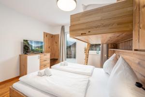 two beds in a bedroom with a large window at Mountain Soulscape by myNests in Ennsling