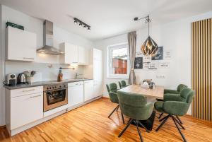a kitchen and dining room with a table and chairs at Mountain Soulscape by myNests in Ennsling