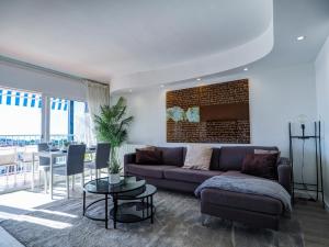 a living room with a couch and a table at Urban Waves by Hello Homes Sitges in Sitges
