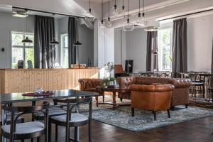 a restaurant with leather furniture and tables and chairs at Wärdshuset Liden in Liden +19 photos