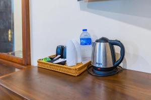a tea kettle and a basket on a table at Bungalow 36 in Kandy