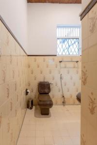 a bathroom with a brown toilet in a room at Bungalow 36 in Kandy +28 photos