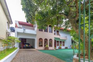 a building with a car parked in front of it at Bungalow 36 in Kandy