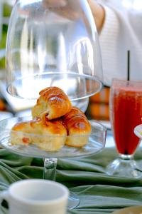 a plate of pastries sitting on a table with a glass plate at Hotel Termal Rio Hondo in Termas de Río Hondo