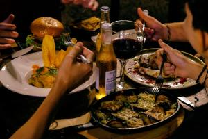a table with plates of food and a bottle of wine at New Western Llanos Stay in Acacías