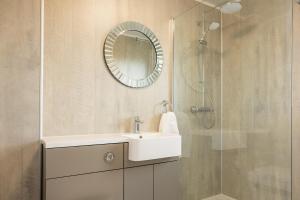 a bathroom with a white sink and a mirror at Self Catering Accommodation - Balivanich, Sleeps 6 in Balivanich