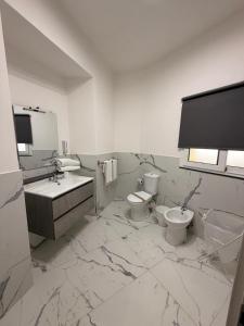 a bathroom with two toilets and a sink at Vulcano Rooms 4 in Catania +25 photos