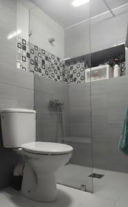 a bathroom with a toilet and a glass shower at Studio Cosy in Tunis +2 photos