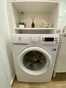 a white washer and dryer in a kitchen at t27 Apartments free parking ingyenes zárt parkoló in Győr