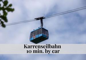 a cable car in the sky with the words karisenisenalam min at CROWN LIVING Babylon Studios Lustenau - Studios nahe Messe und Schweizer Grenze, WLAN, kostenloser Parkplatz, Self Check-in, ideal für Geschäftsreisende und Feriengäste in Lustenau
