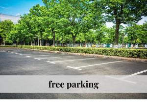 an empty parking lot with trees in the background at CROWN LIVING Babylon Studios Lustenau - Studios nahe Messe und Schweizer Grenze, WLAN, kostenloser Parkplatz, Self Check-in, ideal für Geschäftsreisende und Feriengäste in Lustenau