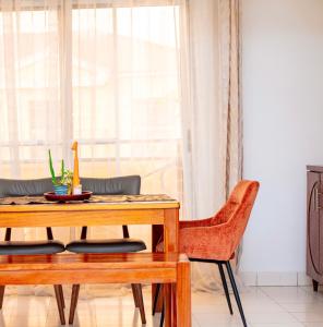 a dining room with a table and chairs at The Bacongo Gem in Brazzaville