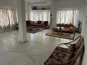 a large living room with couches and a couch at Pappu in Siliguri