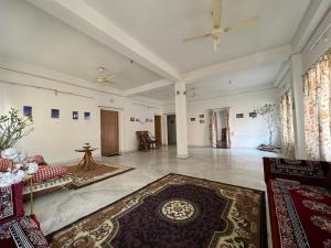 a large living room with a couch and a rug at Pappu in Siliguri
