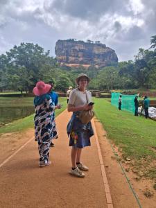 two women standing on a path with a mountain in the background at Villa Mossa Ambalangoda Boutique villa villa in Ambalangoda