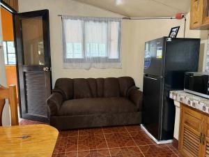 a living room with a couch and a refrigerator at RD's Apartment in Eyeb, Poblacion, Bontoc in Bontoc
