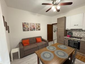 a living room with a couch and a table at Nella Rosa in Monterotondo +7 photos