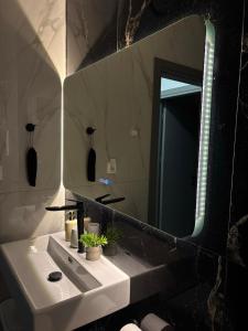 a bathroom with a white sink and a mirror at Sountou home in Xanthi +65 photos