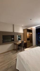 a hotel room with a bed and a desk at Padorama in Nha Trang