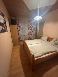 a bedroom with a bed with a light above it at Gasthof Vogelleitner in Sankt Aegyd am Neuwalde