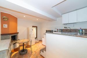a kitchen with a table and a counter top at La Casetta al Corso in Montefiascone
