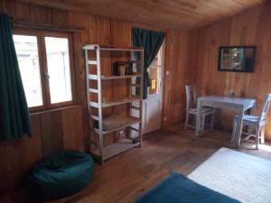 a room with a book shelf and a table at Chalet Banassac in Saint-Ambroix