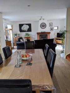 a dining room and living room with a table and chairs at Cottage in Auvergne in Laval-sur-Doulon