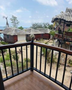 a balcony with a view of a village at Pimmada Hut in Haad Pleayleam