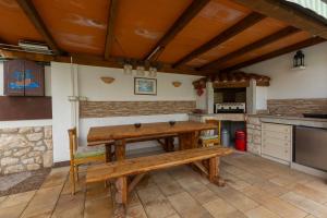 a kitchen with a wooden table and a bench at Villa Luka Nedešćina in Nedeščina