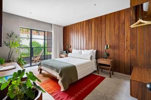 a bedroom with a bed and wooden walls at ALMA Surf Lodge in Punta Mita +68 photos
