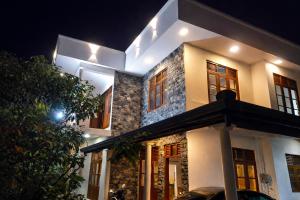 a house with a car parked in front of it at Crystal Pearl Villa in Weligama