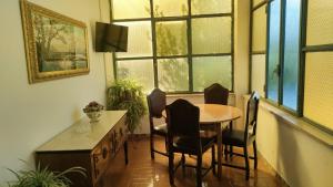 a dining room with a table and chairs and windows at La Candelora Casa Vacanze in Ticchiena