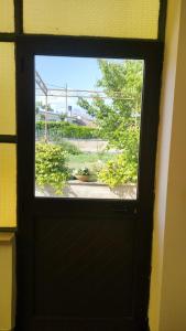 a door with a window looking out at a yard at La Candelora Casa Vacanze in Ticchiena +30 photos