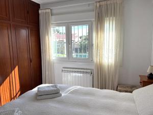 a bedroom with a white bed and a window at Villa Sol in Roquetas de Mar +26 photos