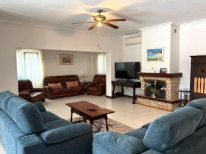 a living room with blue couches and a flat screen tv at Villa Sol in Roquetas de Mar