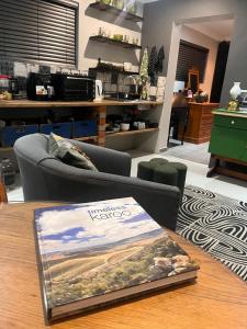 a book sitting on top of a wooden table at Otista Self-Catering Cottage Bloemfontein in Bloemfontein
