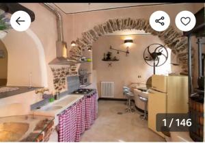 a kitchen with a sink and a stove top oven at Il Nuovo Vecchio Frantoio di Gardan Con Piscina in Vignana +57 photos