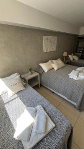 a bedroom with two beds with towels on them at Hotel Termal Rio Hondo in Termas de Río Hondo