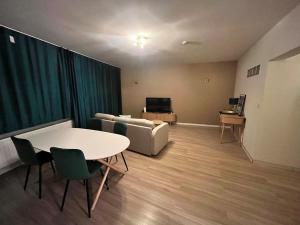 a living room with a couch and a table and chairs at Vilvoorde city center in Vilvoorde