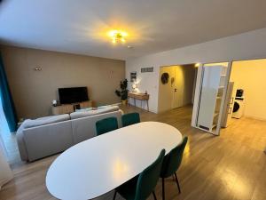 a living room with a white table and a couch at Vilvoorde city center in Vilvoorde +9 photos