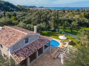 an external view of a villa with a swimming pool at Villa Dias by Elayan Villas Corfu in Karousádes