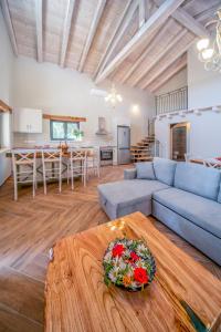 a living room with a blue couch and a table at Villa Dias by Elayan Villas Corfu in Karousádes