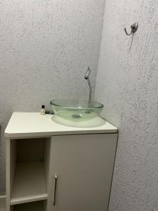 a sink with a glass bowl on top of a cabinet at Vivendas do Paiol in Guapimirim +38 photos