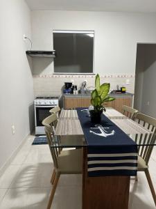 a kitchen with a table with a plant on it at Vivendas do Paiol in Guapimirim